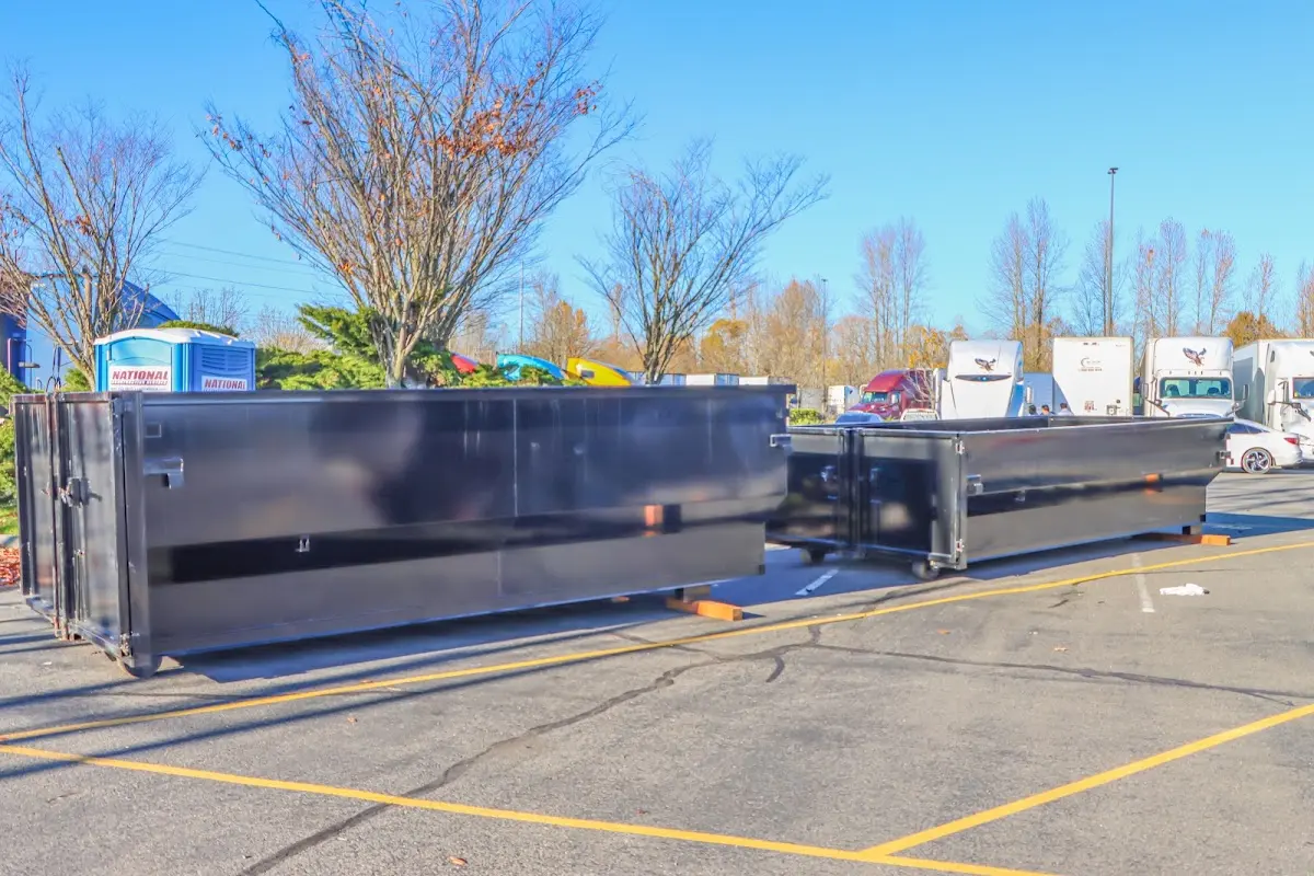 Professional dumpster rental service with roll-off container on residential driveway in Lake Hallie